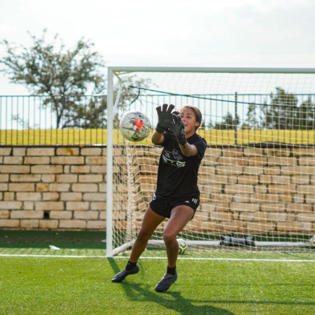 young goalie blocking a ball